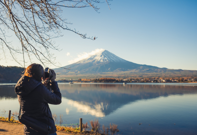 A Women Clicking A Picture Of Mount Fuji A Women Clicking A Picture Of Mount Fuji