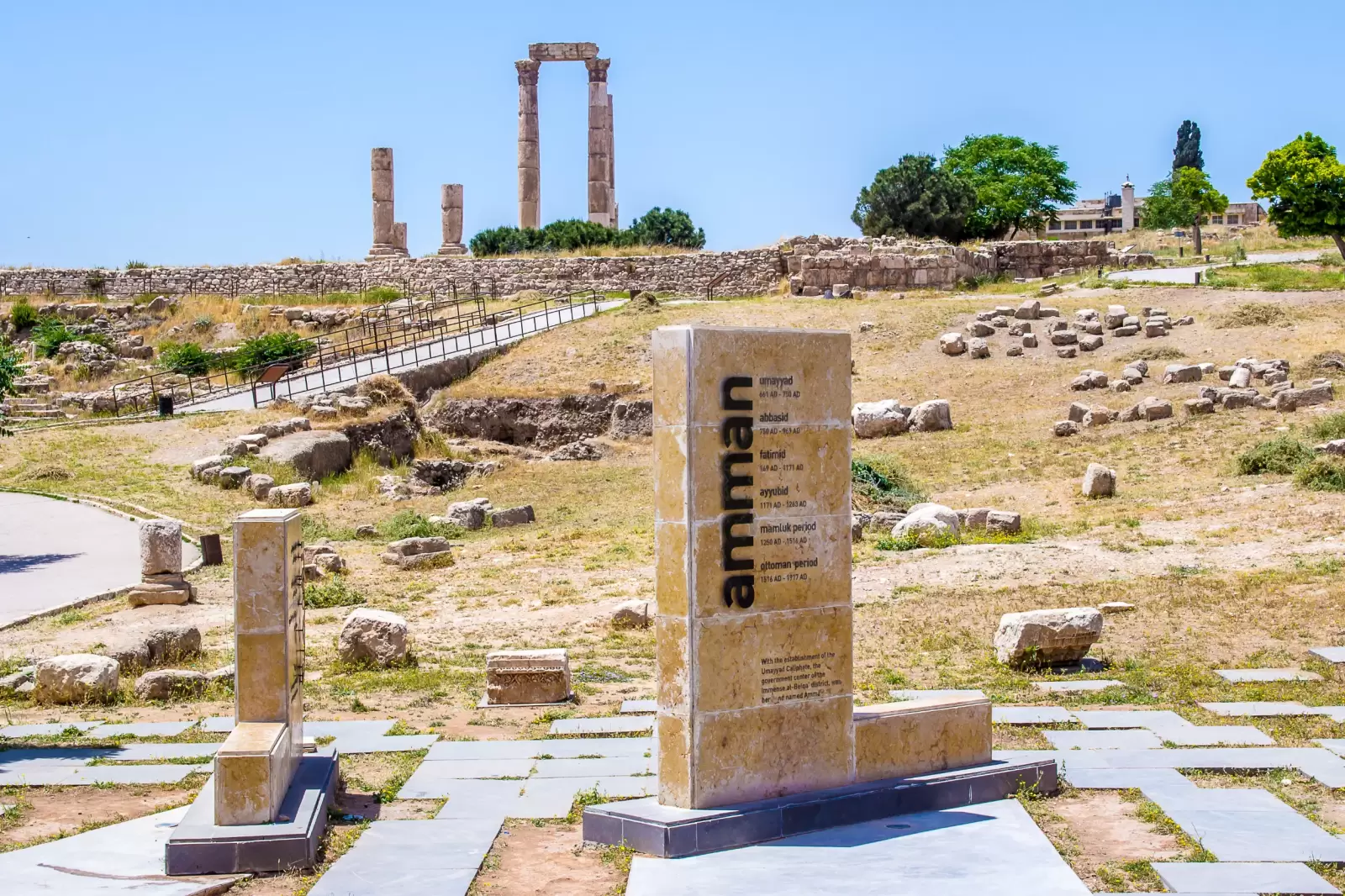 amman citadel with the name of the city written