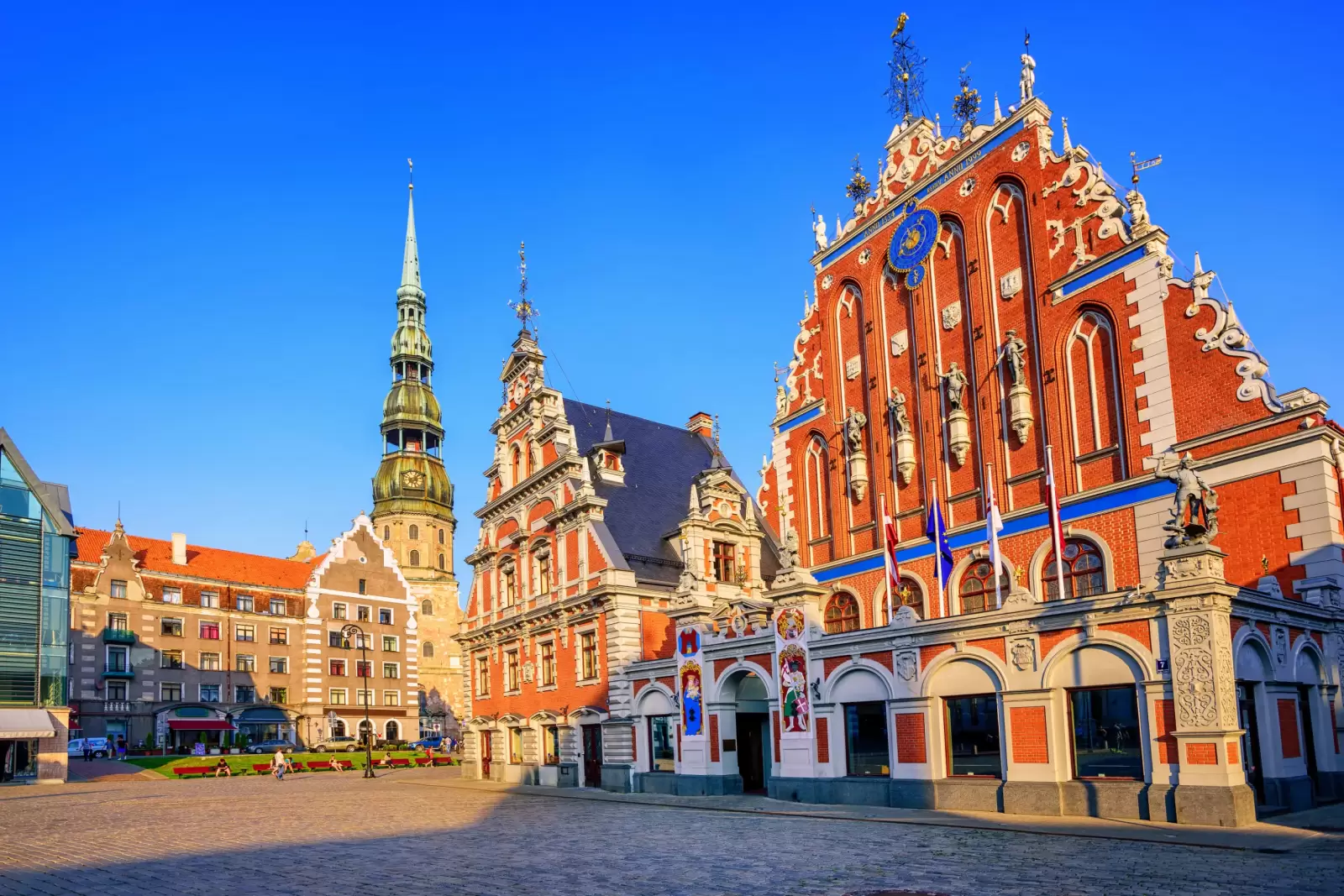 city hall square with house of blackheads and saint peter church in old town of riga