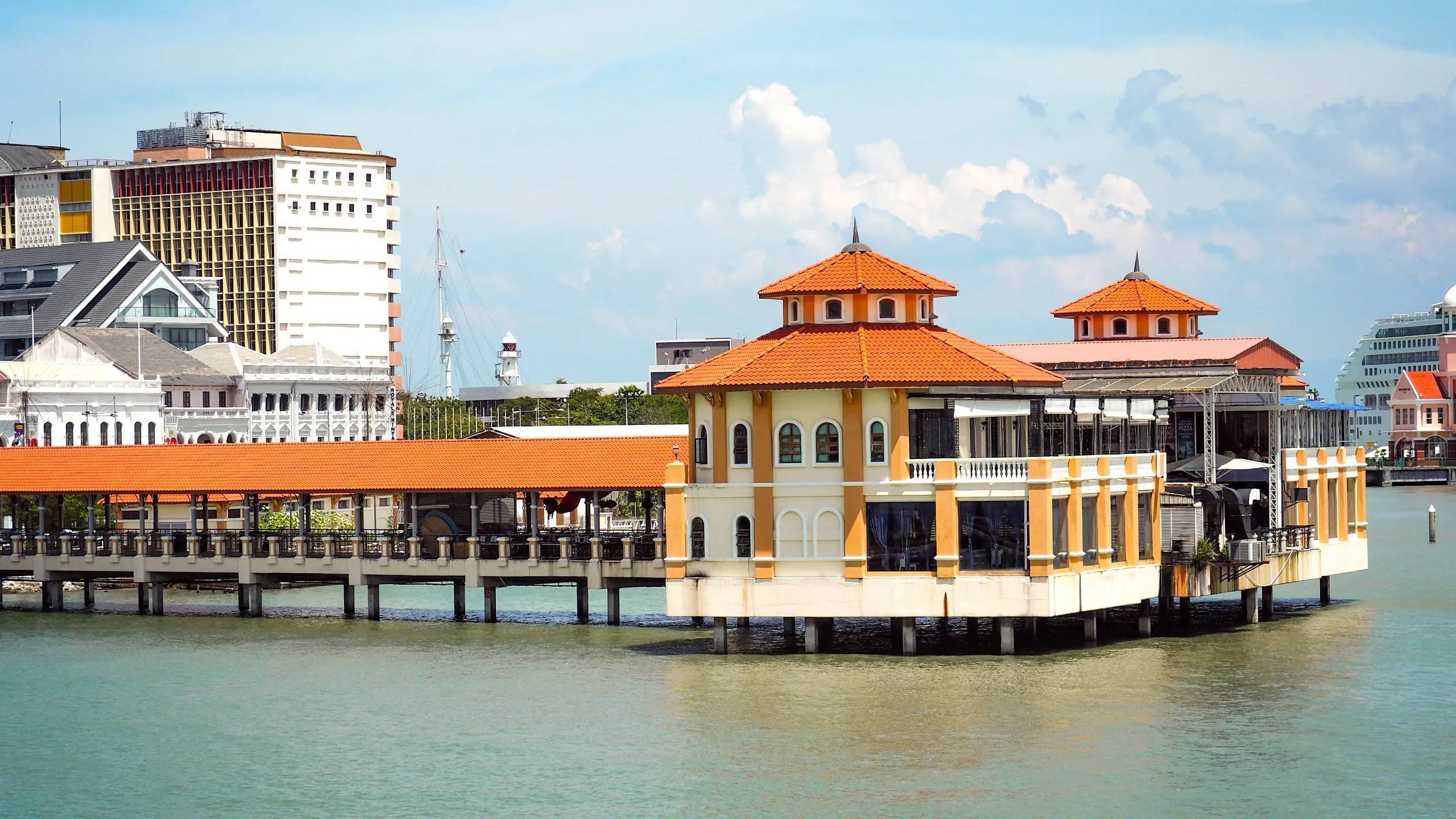 commercial ships in port with sea and blue sky and clouds background in penang