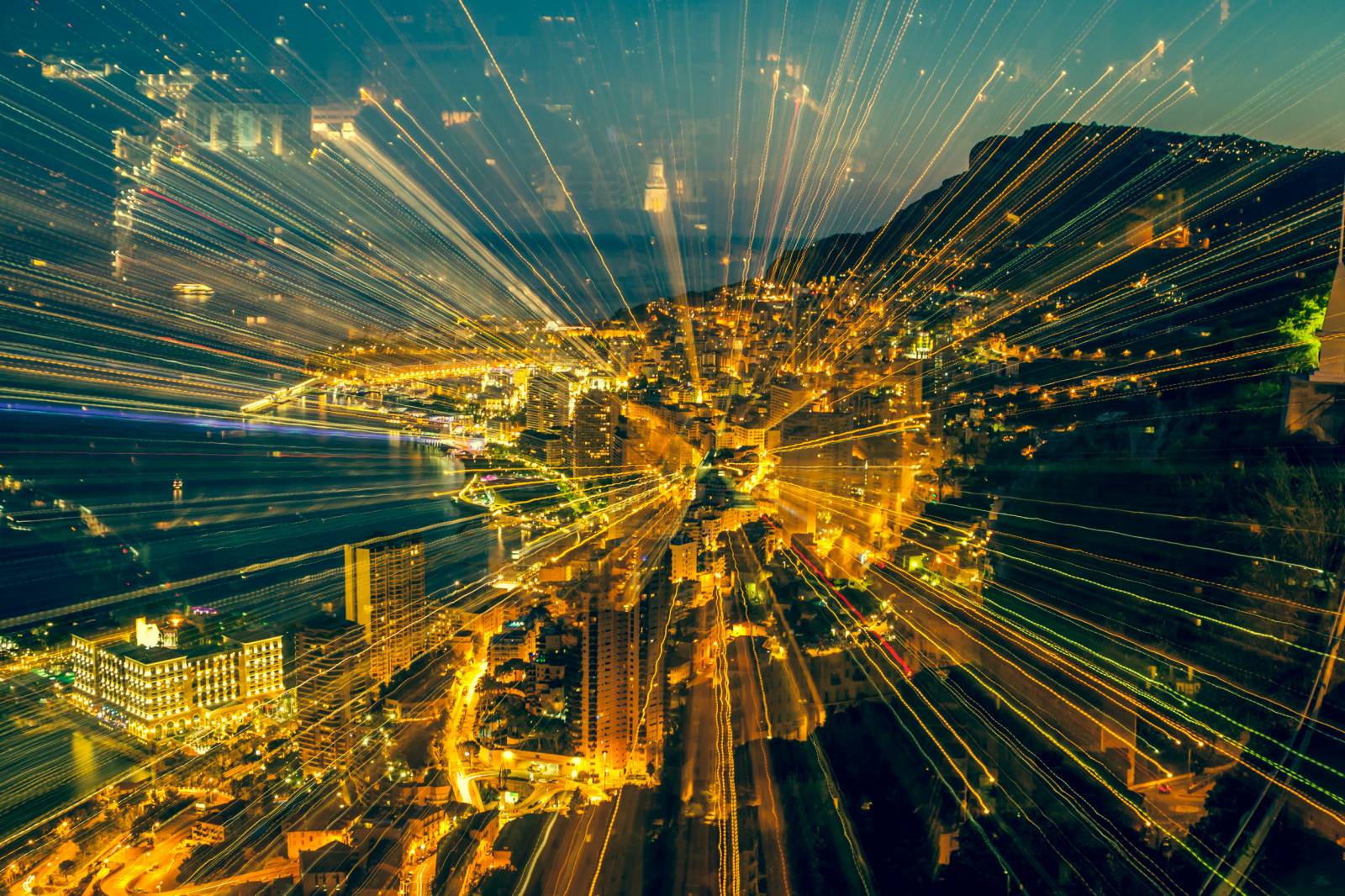 Cityscape at night with dynamic light streaks creating a zoom effect