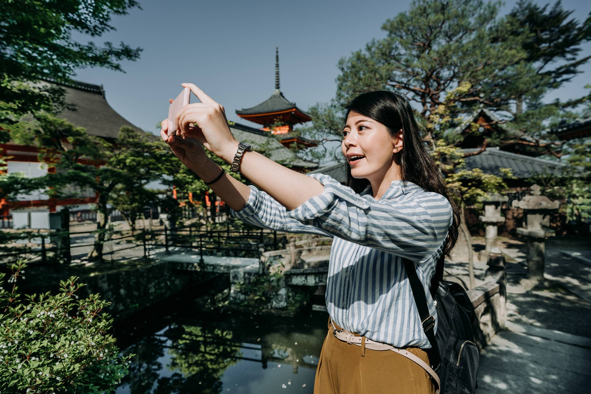 Girl Tourist Holding Cellphone Camera App Taking Picture Of Beautiful Scenery In Japanese Garden