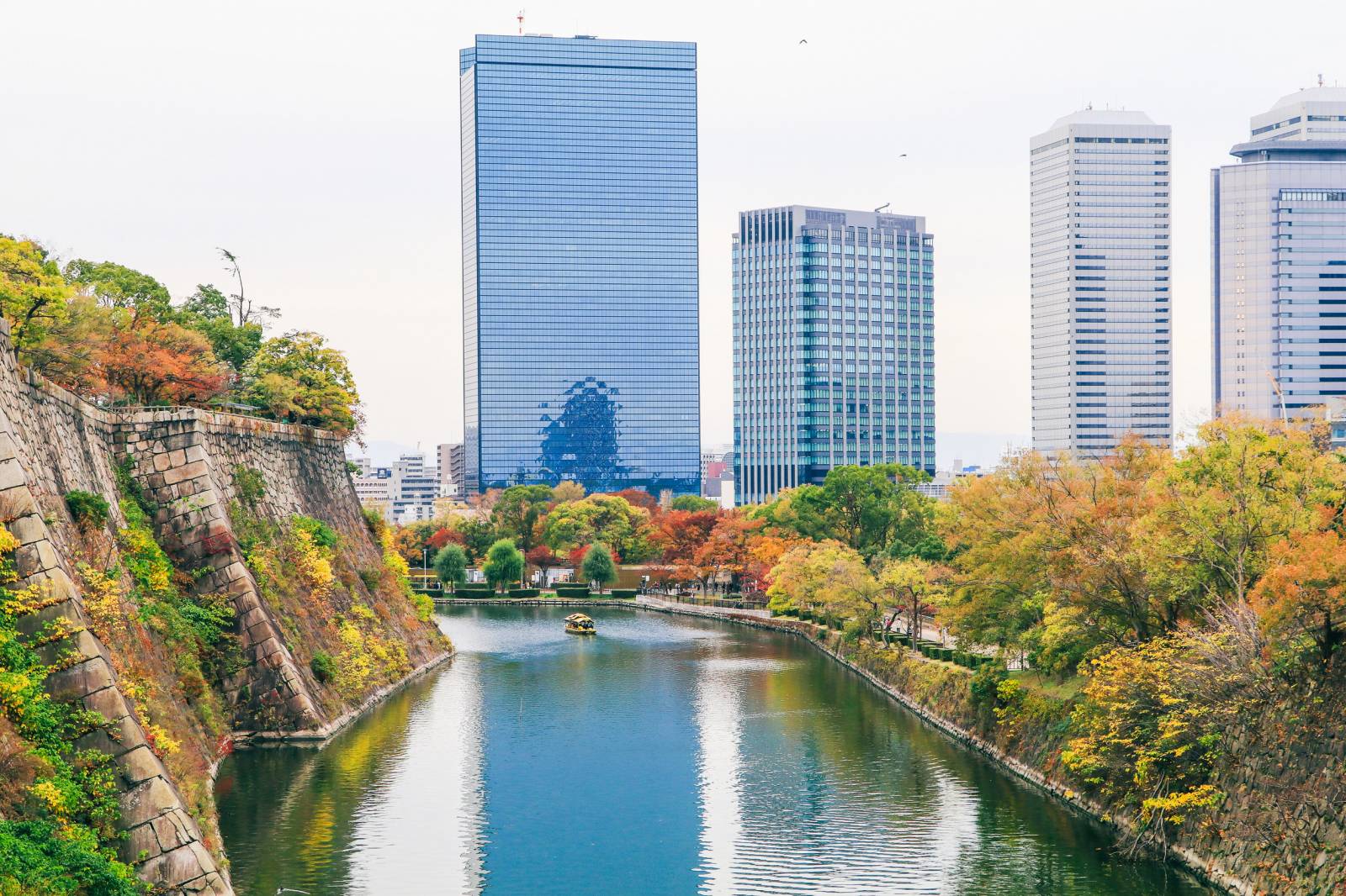Osaka Castle Moat And Modern Skyline