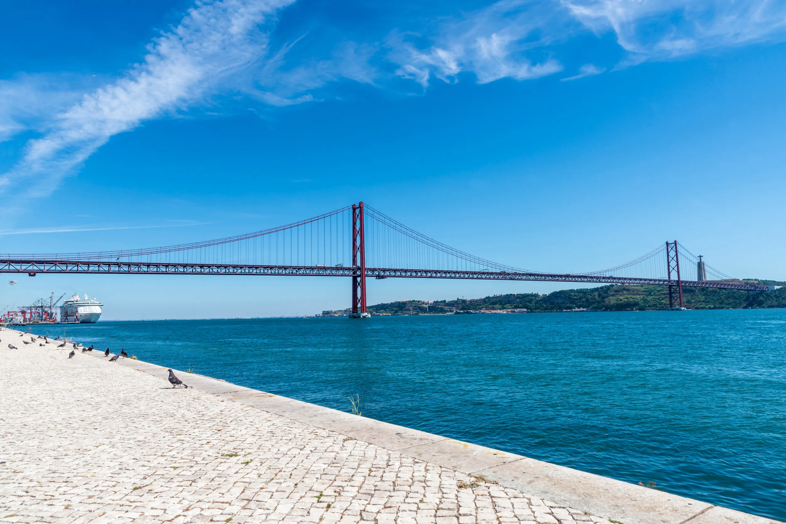 tagus river and cristo rei the statue of jesus in lisbon portugal