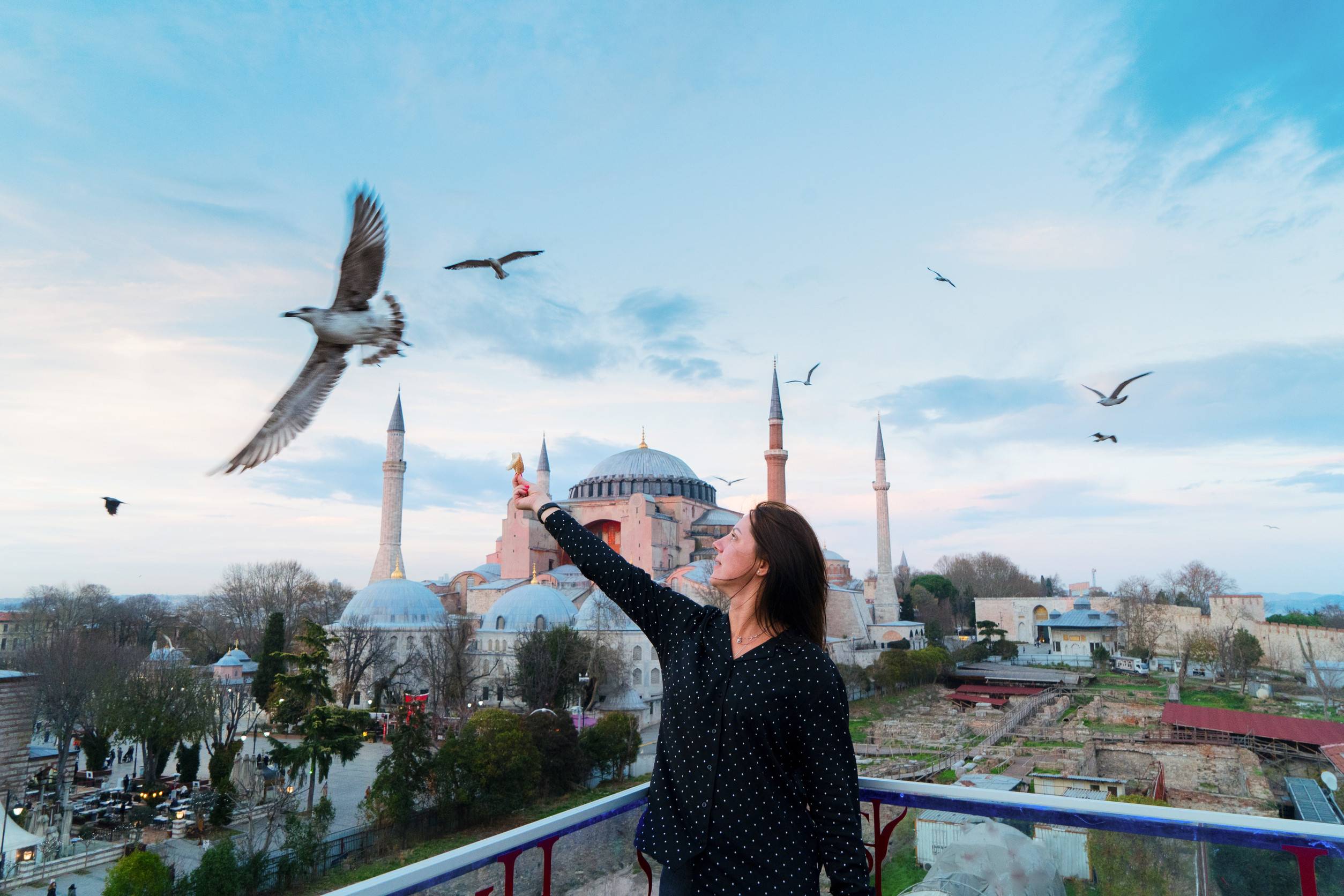 Tourist Girl Feeding Seaguls In Front Of Hagia Sophia Cathedral Church Istanbul Turkey